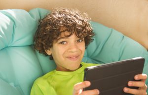Smiling Boy Holding Tablet